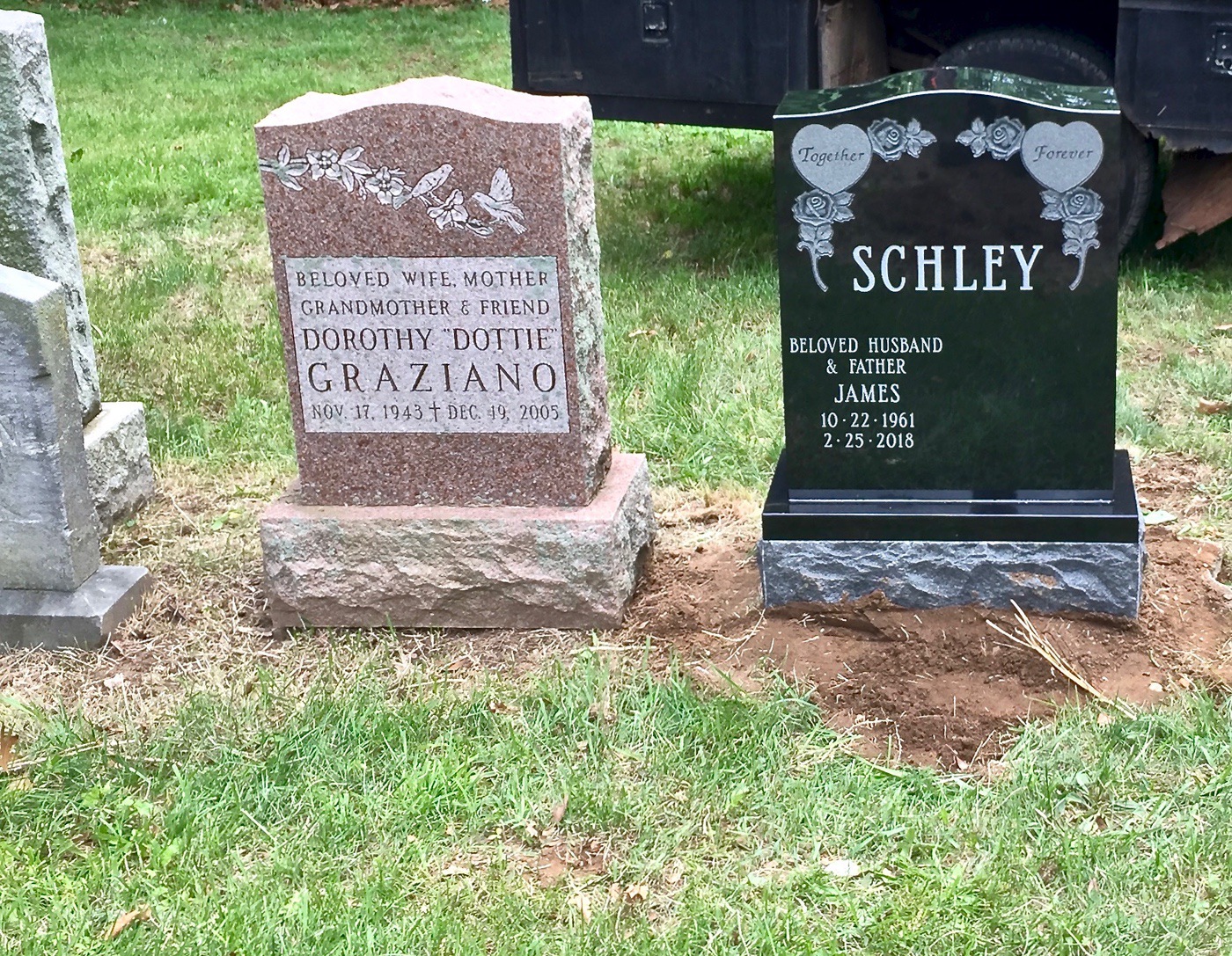 Single upright granite headstone with floral etching